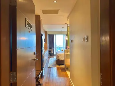 a hallway with a door leading to a bedroom at The Residences at Novotel Tower in Manila