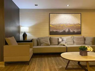 a living room with a couch and a table at Air Residences - Pool View near Airport - 1159 in Manila