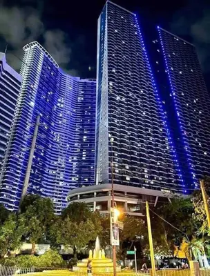 a large building with blue lights on it at Air Residences - Balcony City View near Airport - 3521 in Manila