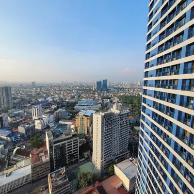 an aerial view of a city with a tall building at Air Residences - Balcony City View near Airport - 3521 in Manila