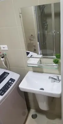 a white bathroom with a sink and a mirror at One Bedroom Condo Unit Fame Residences Tower 4 in Manila