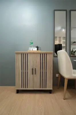 a wooden cabinet and a white chair in an office at Newly Renovated Pasig Studio with Pool and Fiber Wi-Fi in Manila