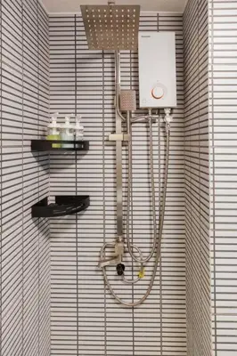 a shower in the corner of a room at Newly Renovated Pasig Studio with Pool and Fiber Wi-Fi in Manila