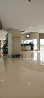 a shopping cart in a lobby with a christmas tree at Moa Staycation pasay by mj in Manila