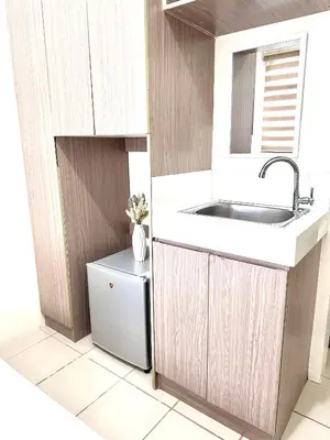 a small kitchen with a sink and a refrigerator at Hotel in Mandaluyong in Manila