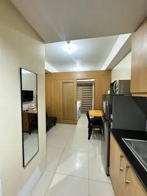 a room with a kitchen and a dining room at shell staycation in Manila