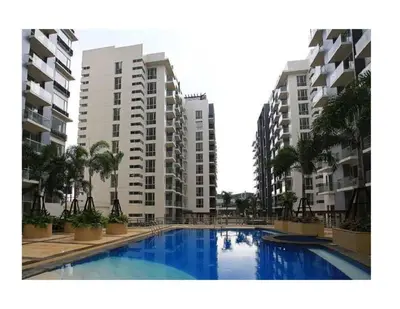 a swimming pool in front of some apartment buildings at Newport City Condos in Manila