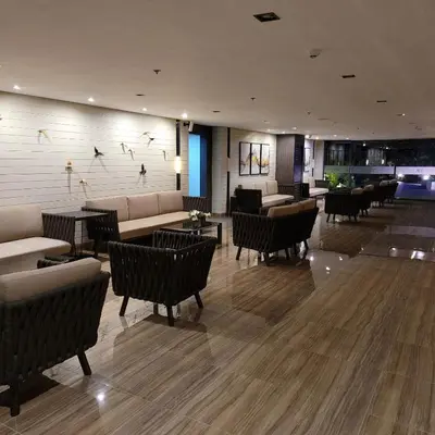 a lobby with couches and tables and chairs at Air Residences - High Floor City View near Airport - 5759 in Manila
