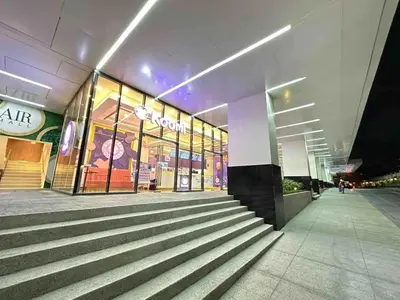 a store front of a shopping mall at night at Air Residences - High Floor City View near Airport - 5759 in Manila