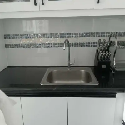 a kitchen with a sink and a counter top at SMDC Coast Residences in Manila