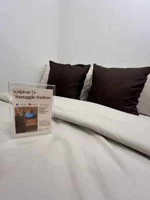 a bed with a sign sitting on top of it at Shore 2 Tower 3 in Manila