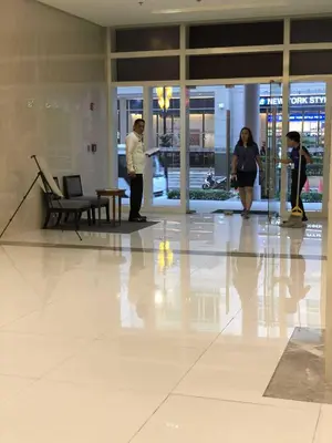 a couple of people standing in a building at Ivy Condotels Unit -101Newport Boulevard in Manila