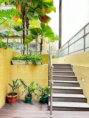 a set of stairs with potted plants in a building at Tranquil Space Across Airport NAIA 3 in Manila