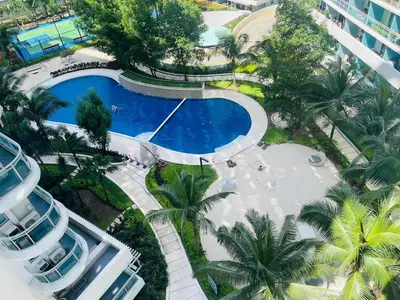 an overhead view of a swimming pool in a resort at KYH STAYCATION 2BR by Azure Residences Near Airport in Manila