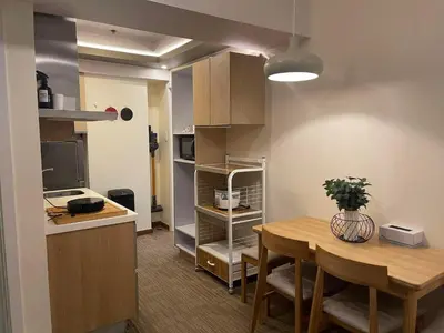 a kitchen and dining room with a table and a kitchen gmaxwell gmaxwell gmaxwell at KYH STAYCATION 2BR by Azure Residences Near Airport in Manila