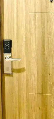 a door with a door handle with a phone on it at Stunning Suite with Balcony near MOA in Manila