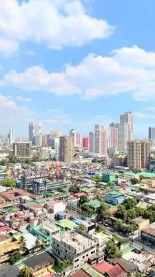 a cityscape of a city with tall buildings at Stunning Suite with Balcony near MOA in Manila