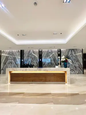 a lobby with a bench in the middle of a room at Stunning Suite with Balcony near MOA in Manila