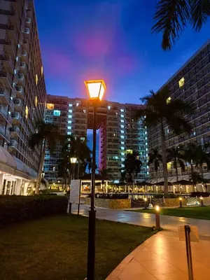 a street light in front of a building at night at Mall of Asia 2 Bedrooms in Manila