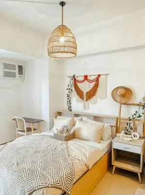 a bedroom with a large bed and a table at Venice Luxury Residences Studio McKinley Hill in Manila