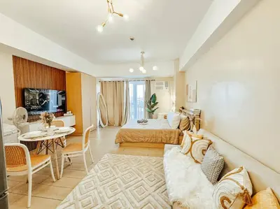 a large room with a bed and a living room at Venice Luxury Residences Studio Taguig City in Manila