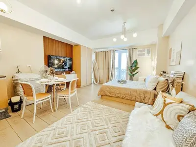 a living room with a bed and a dining room at Venice Luxury Residences Studio Taguig City in Manila