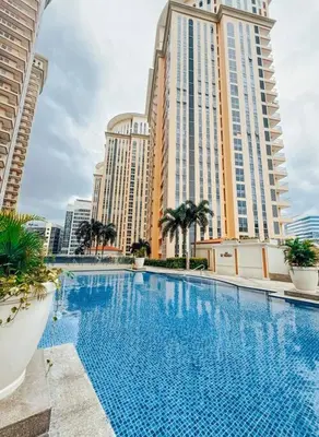 a large swimming pool in front of tall buildings at Venice Luxury Residences Studio Taguig City in Manila
