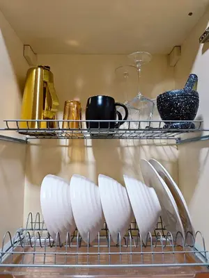 a rack with white plates on it in a kitchen at Casa Prian in Manila