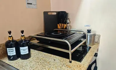 a counter with two bottles of wine on a stove at Casa Prian in Manila