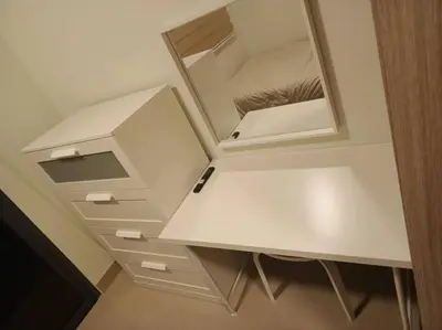 a white dressing table with a mirror on it at Candid Suite by ARL in Manila