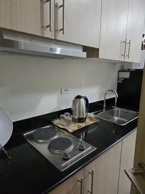 a kitchen with a stove top with a tea pot on it at 1554 Apartel Breeze Resident in Manila