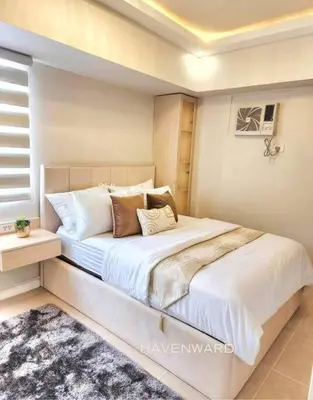 a bedroom with a large bed with white sheets and pillows at Luxe 3BR unit in the heart of BGC Taguig in Manila