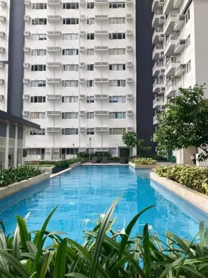 a large blue swimming pool in front of a building at Luxe 3BR unit in the heart of BGC Taguig in Manila