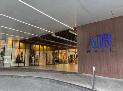 a building with an entrance to an mall at R7 Premier Suites - 1 bedroom in Air Residences in Manila