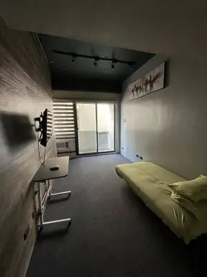 a bedroom with a bed and a desk and a window at 63 sqm Unit for GET TOGETHER at Poblacion, Makati with Private Parking in Manila