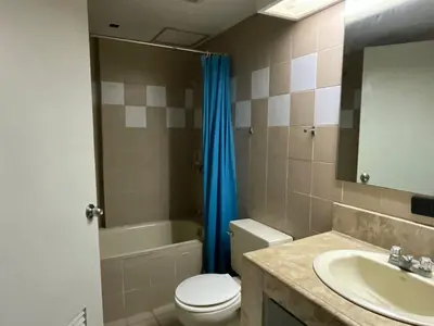 a bathroom with a toilet and a sink and a mirror at 63 sqm Unit for GET TOGETHER at Poblacion, Makati with Private Parking in Manila