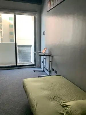 a bedroom with a bed and a desk with a laptop at 63 sqm Unit for GET TOGETHER at Poblacion, Makati with Private Parking in Manila