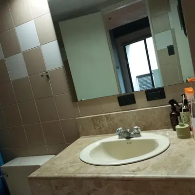 a bathroom with a sink and a mirror and a toilet at 63 sqm Unit for GET TOGETHER at Poblacion, Makati with Private Parking in Manila