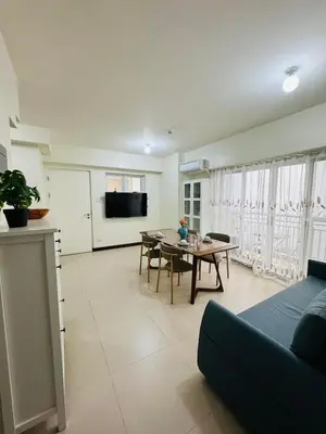 a living room with a couch and a table at FAIRLANE residences in Manila