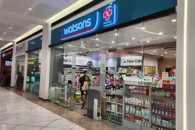 a man is standing in front of a store at Spacious Pool View 2br 2bath Apt in Makati in Manila
