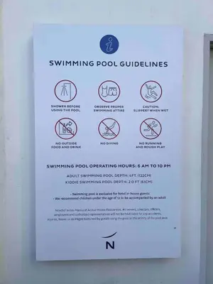 a sign on a wall that says swimming pool guidelines at Novotel Residential Tower at Acqua Private Residences Mandaluyong - Makati in Manila