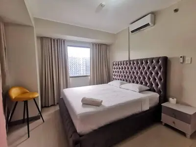 a bedroom with a large bed and a window at S Residences Two Beds Room Near MOA Pasay Manila in Manila