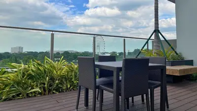 a table and chairs on a balcony with a view at SMDC Coast Residences in Manila