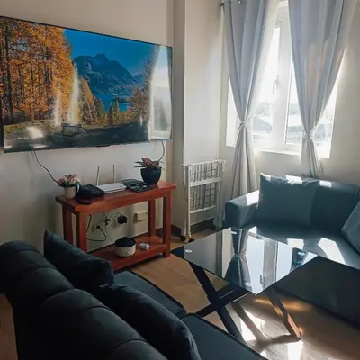 a living room with a couch and a glass table at Happy Stays D - 300mbps - 65