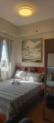 a bedroom with a bed and a large window at Happy Stays D - 300mbps - 65