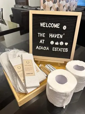 a sign that says welcome to the haven at azaza estates with toilet paper at The Haven at Acacia Estates in Manila