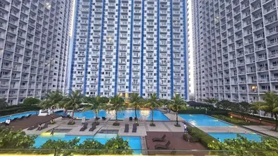 an aerial view of a large building with two pools at Uno - Condo Unit in SM Jazz Residences in Manila
