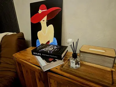 a table with books and a picture of a woman on it at Uno - Condo Unit in SM Jazz Residences in Manila
