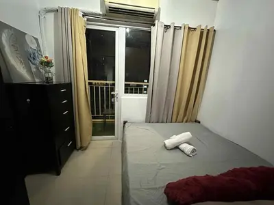 a bedroom with a bed with two towels on it at SD 2 staycation in Manila