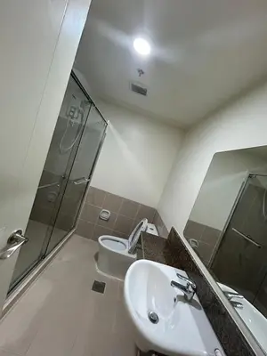 a bathroom with a sink and a shower and a toilet at blue sky viewing in Manila